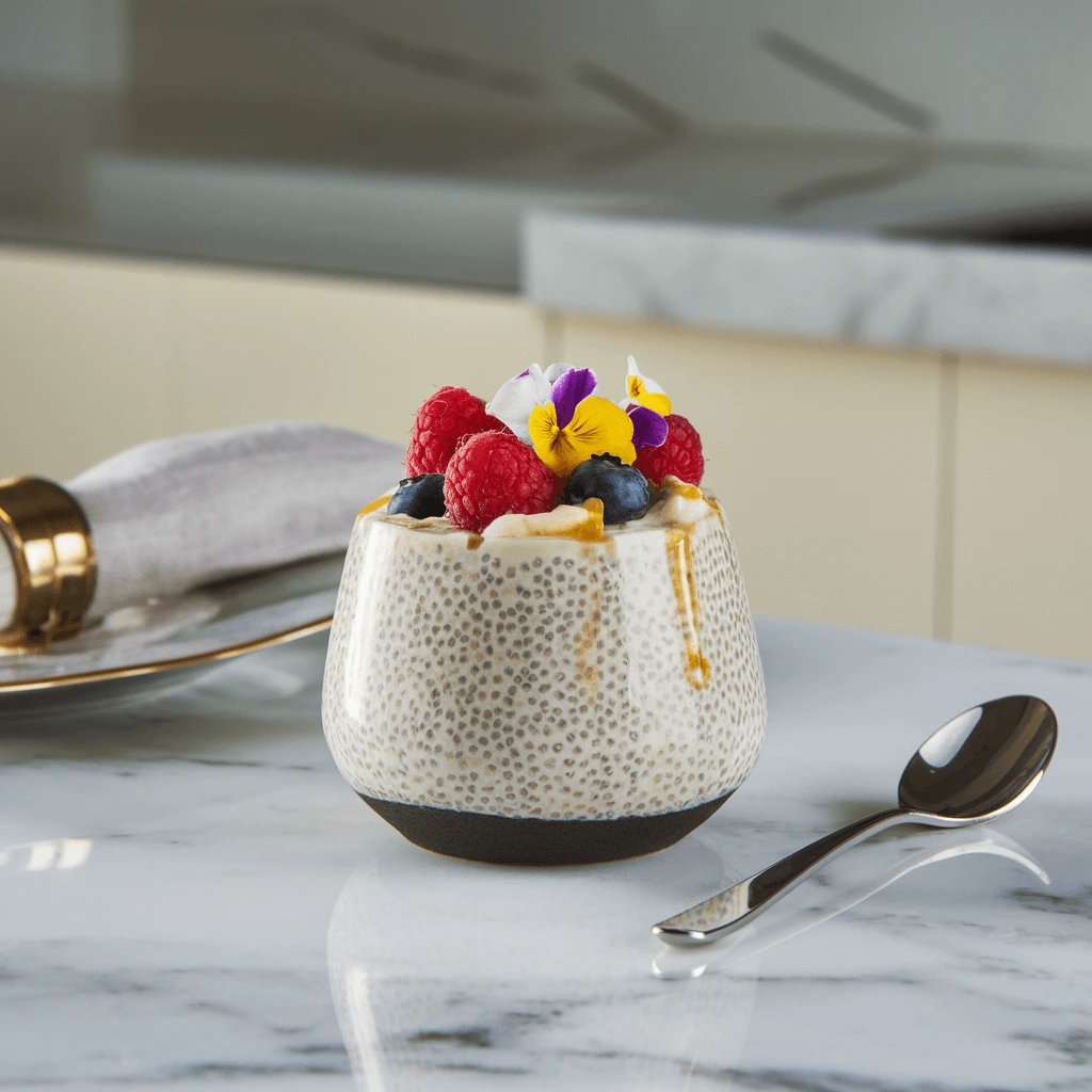 Healthy chia seed pudding served in a ceramic cup with fresh fruits, perfect for a nutritious breakfast.